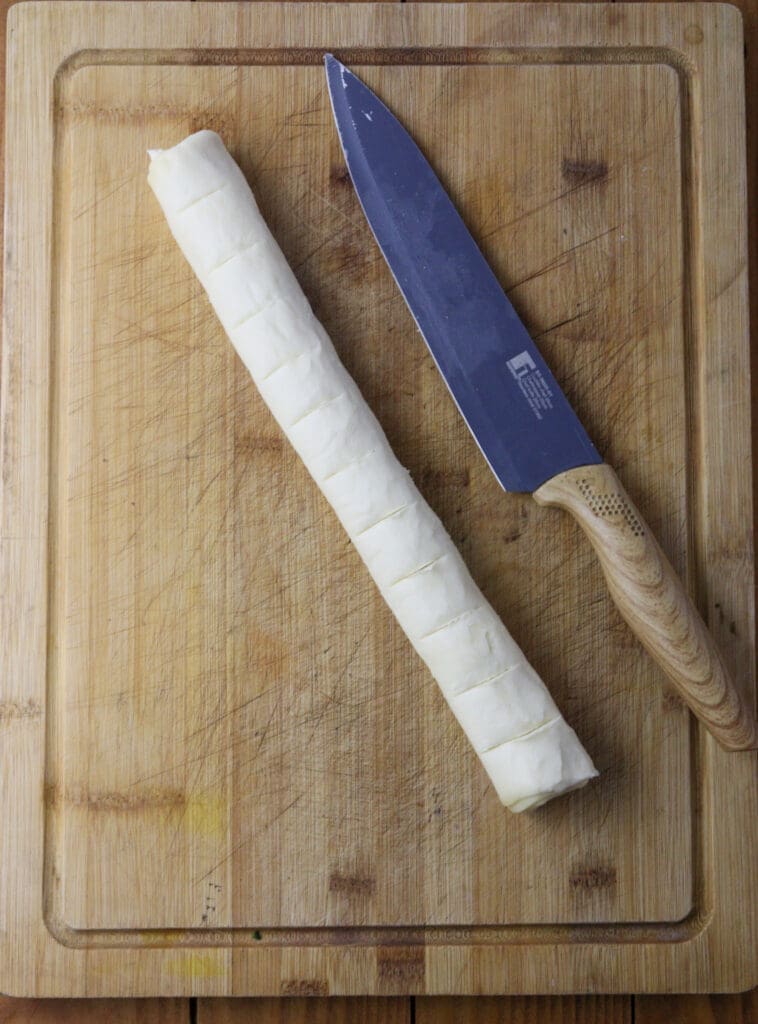 Image showing how to mark puff pastry dough to evenly split it into 12 pieces.